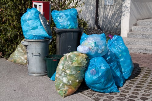 Household waste being loaded into a skip